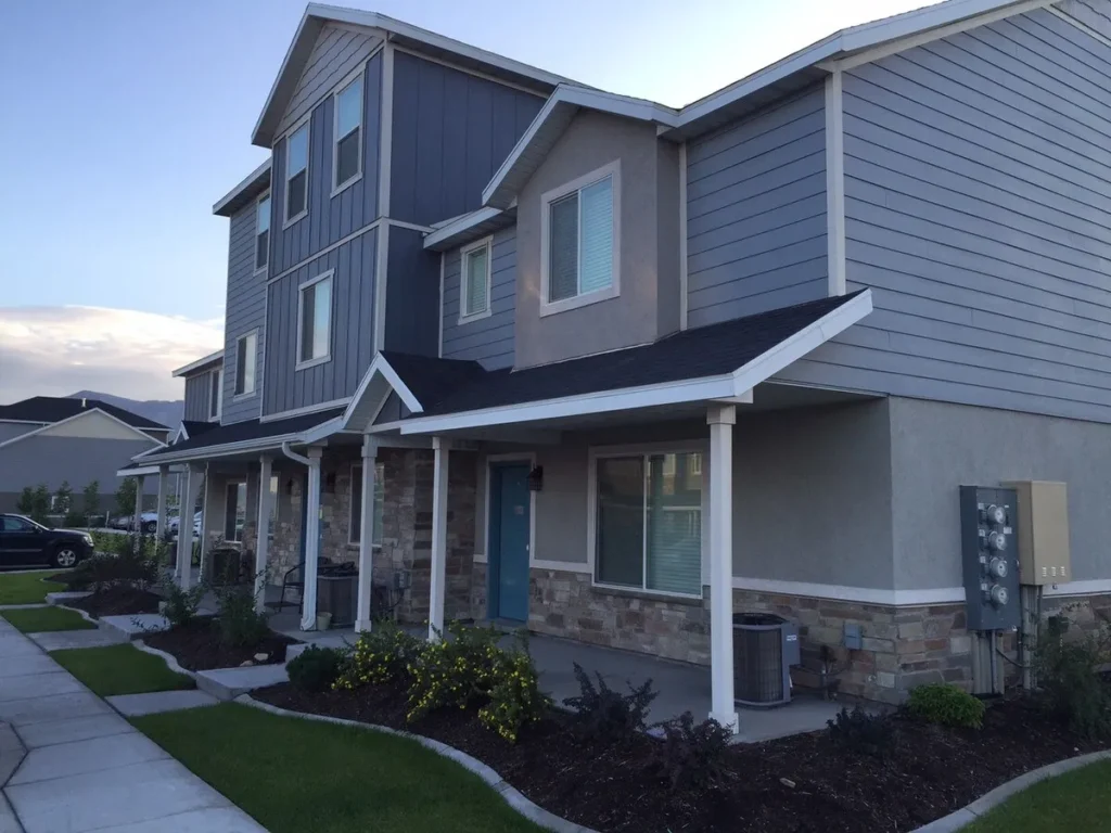 Row of modern multi-story townhomes with professional landscaping, an example of high-density land use entitlement achieved by Mike Miller.