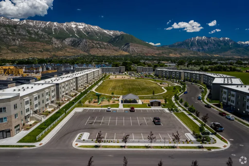 Aerial view of a residential community featuring a pool and playground, illustrating ILCC's expertise in site feasibility and residential master planning.