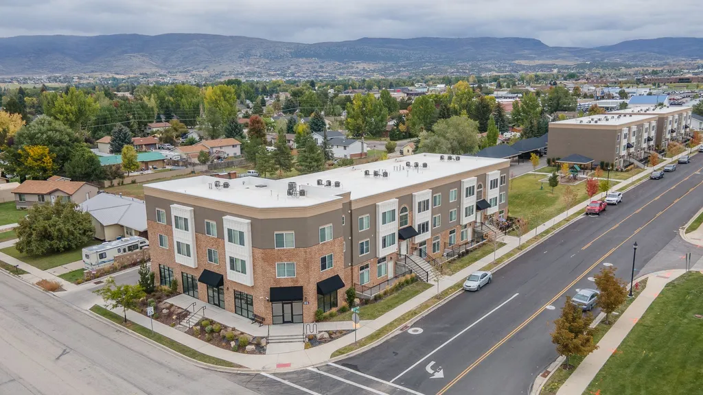 An aerial drone photograph of a completed mixed-use residential and commercial building, highlighting ILCC’s expertise in complex urban land use and entitlement.