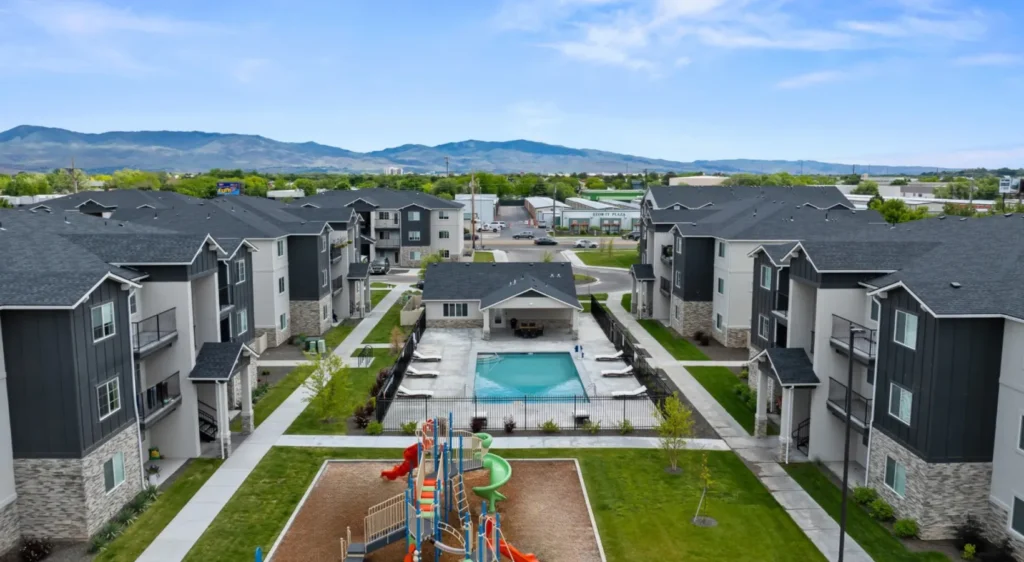 Comprehensive aerial view of a large residential development site with mountains in the background, showcasing effective land use consulting and site layout.